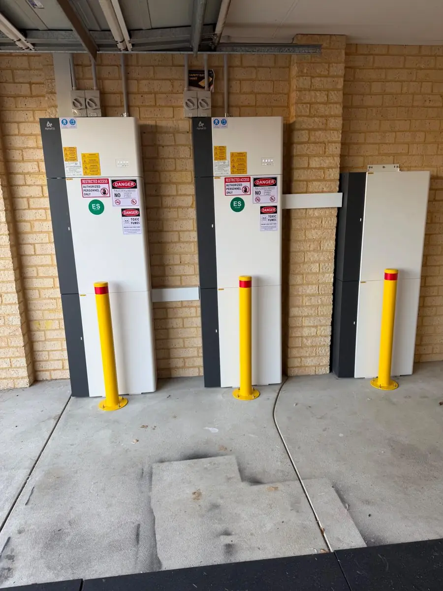 Three AlphaESS units in a cream brick garage